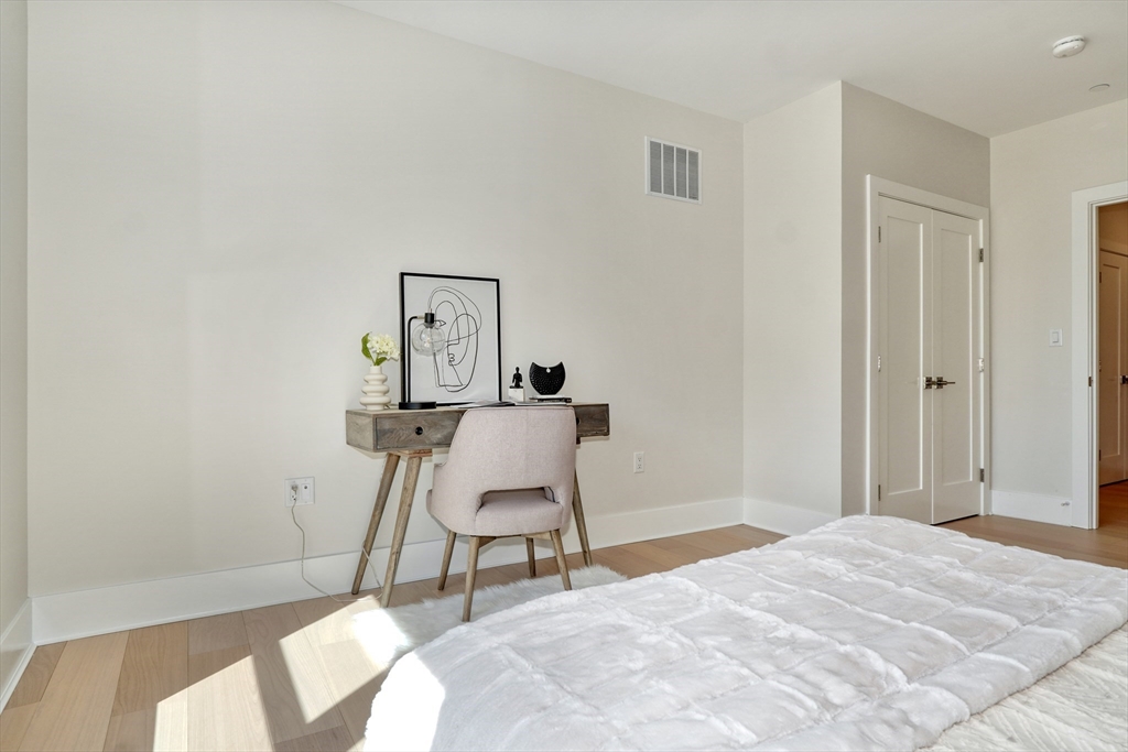 62 Foundry Street, Unit 309 Wakefield, MA 01880 - Photo 17 of 36 a workspace room with a bed and a chair