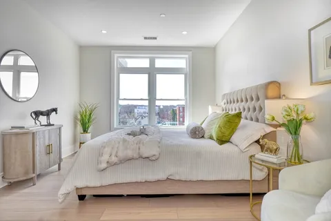 a bedroom with a bed couch and a window