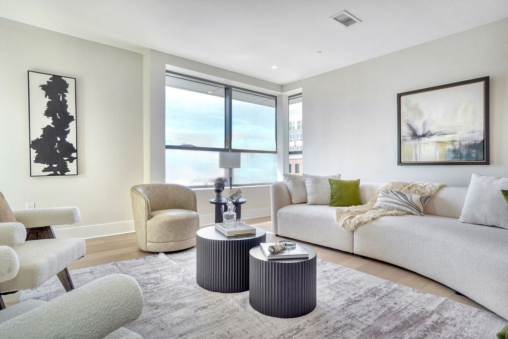 62 Foundry Street, Unit 309 Wakefield, MA 01880 - Photo 8 of 36 a living room with furniture and a large window