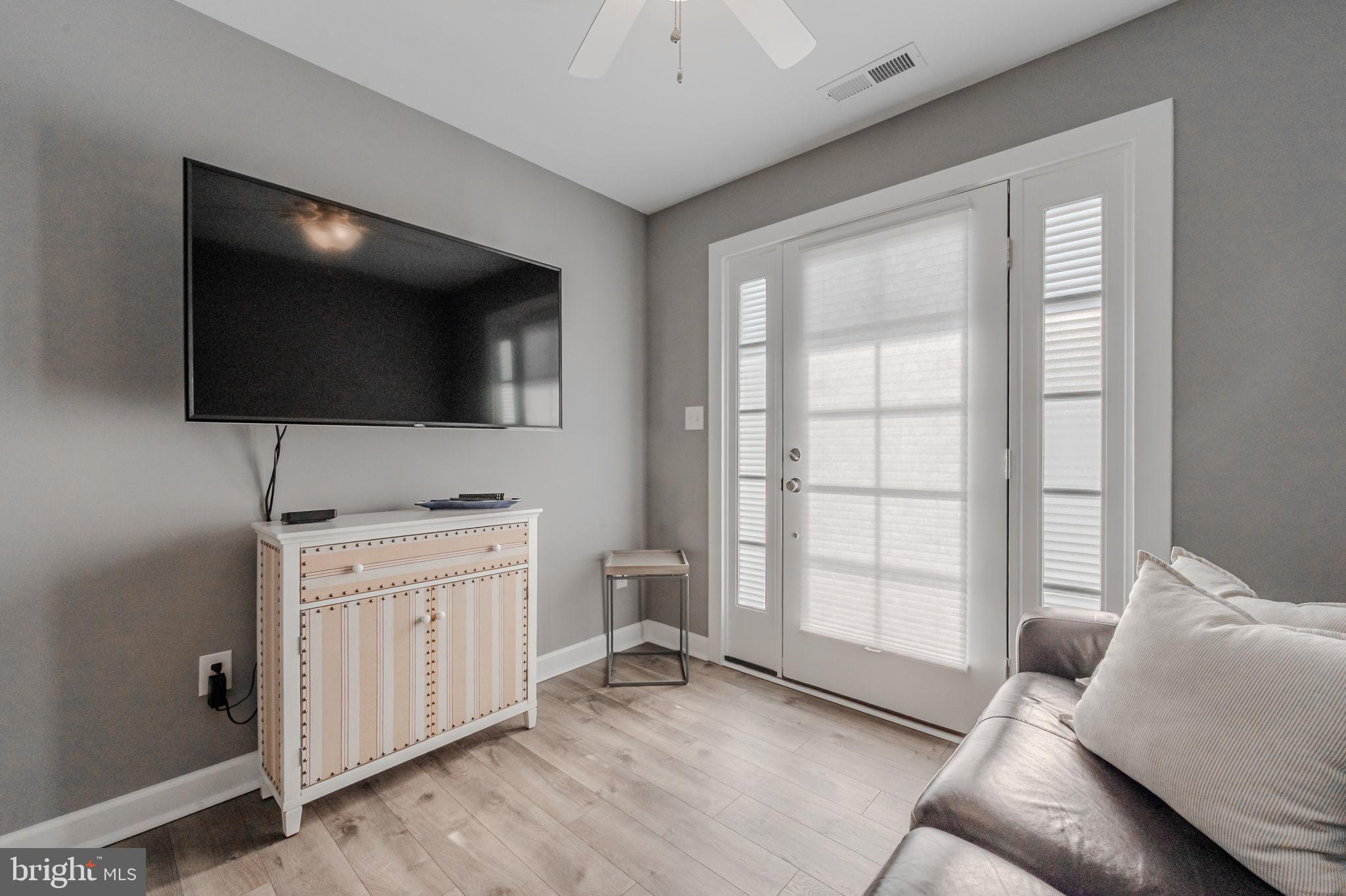 100 Anglers Road, Unit A4 Lewes, DE 19958 - Photo 11 of 57 a living room with furniture and a flat screen tv