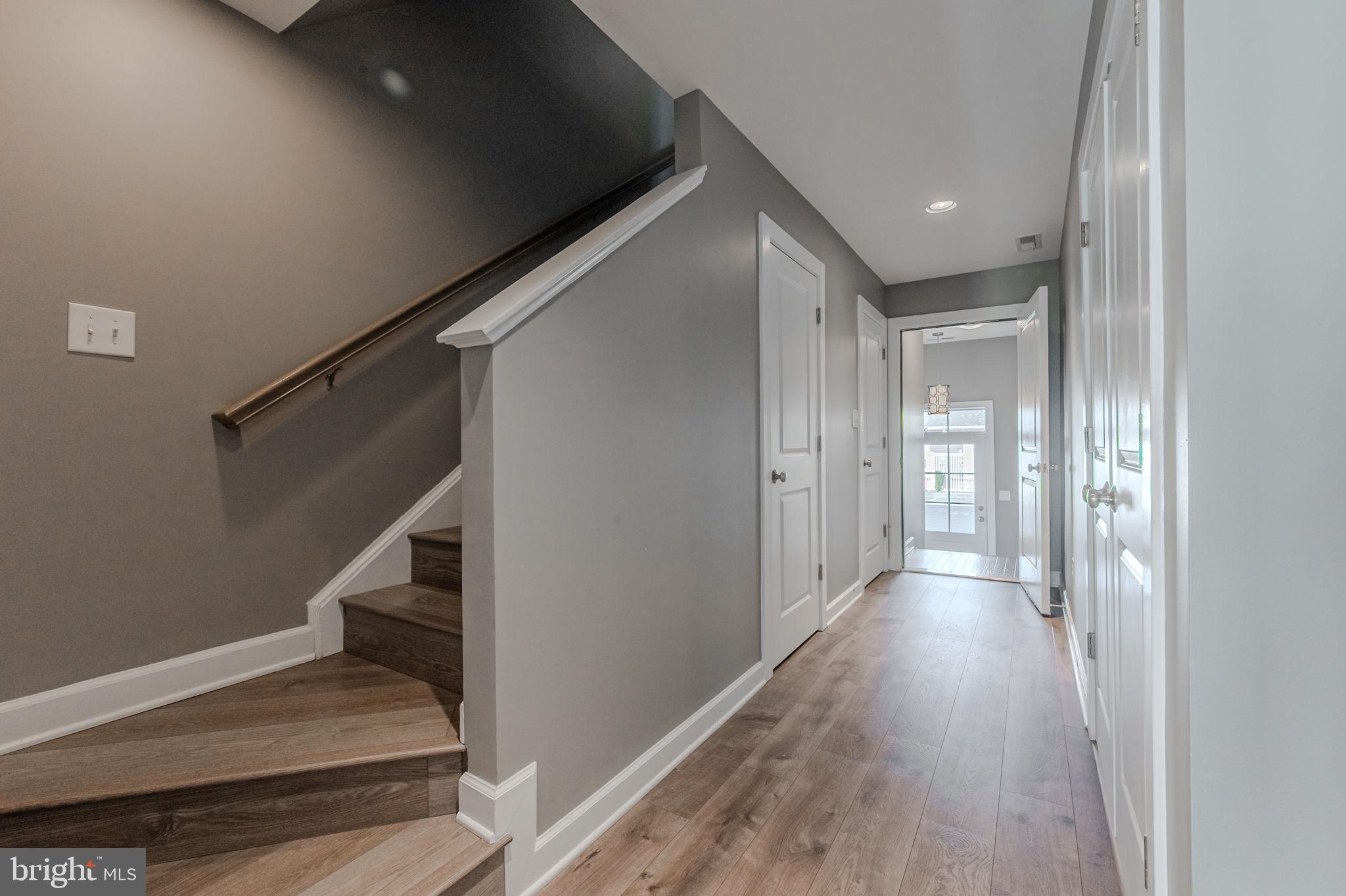 100 Anglers Road, Unit A4 Lewes, DE 19958 - Photo 15 of 57 a view of hallway with stairs and wooden floor
