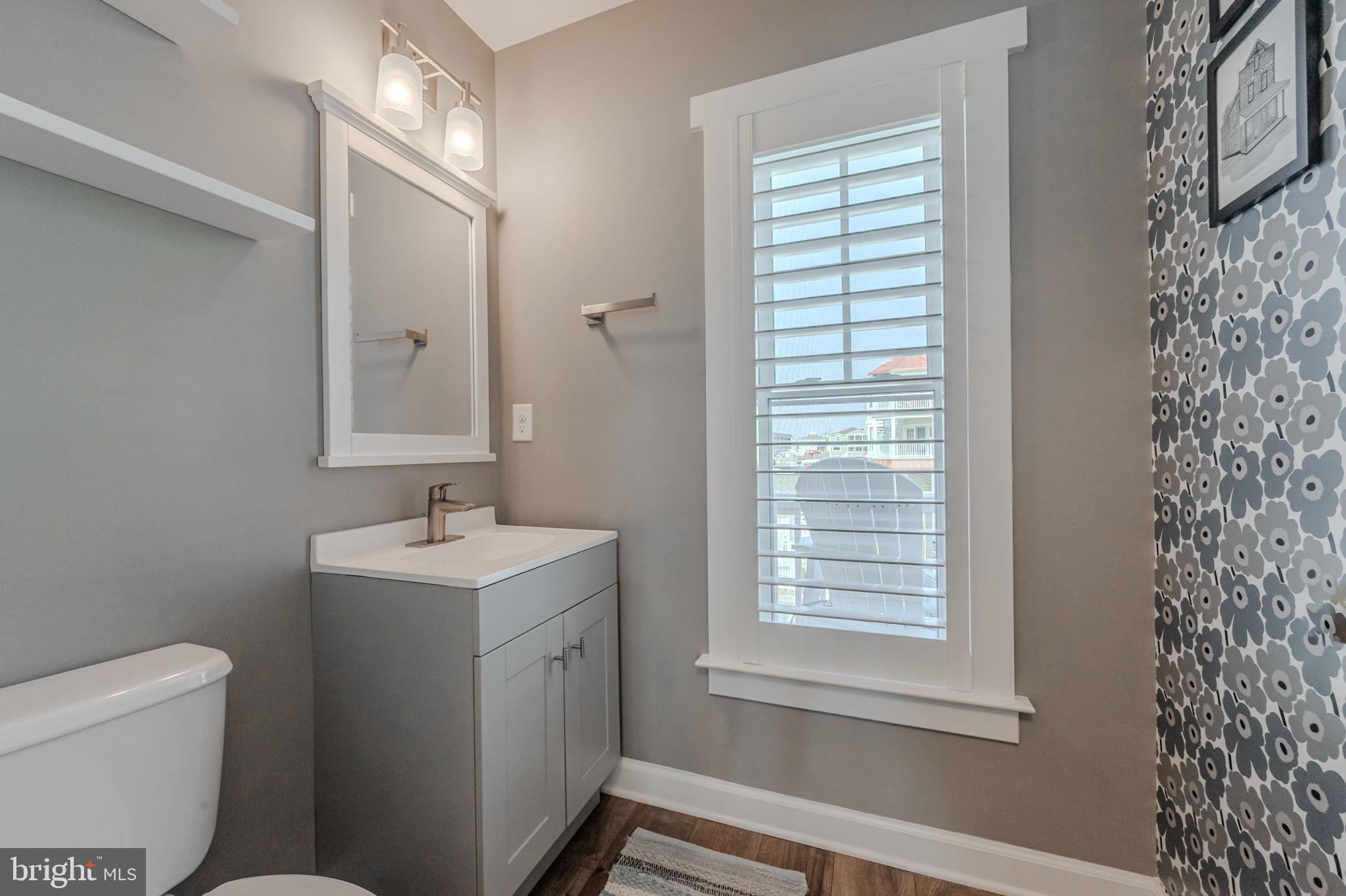 100 Anglers Road, Unit A4 Lewes, DE 19958 - Photo 17 of 57 a bathroom with a toilet sink and mirror