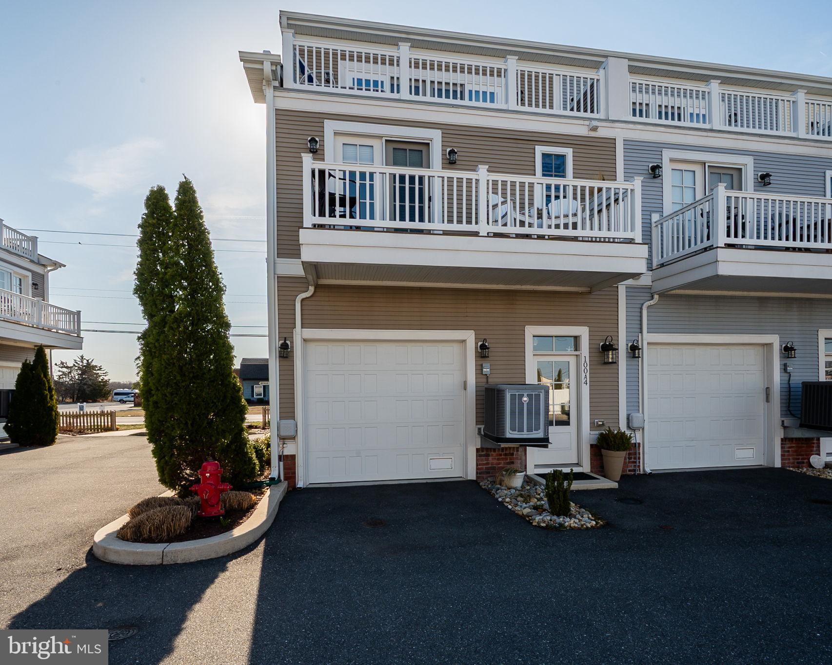 100 Anglers Road, Unit A4 Lewes, DE 19958 - Photo 2 of 57 a front view of a house with a yard and garage