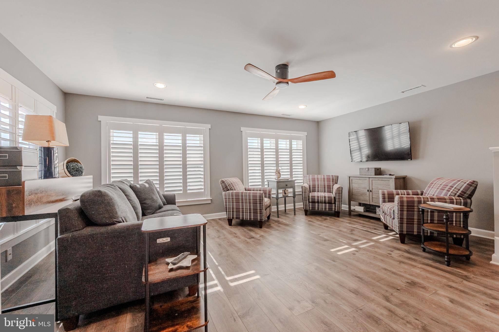 100 Anglers Road, Unit A4 Lewes, DE 19958 - Photo 28 of 57 a living room with furniture flat screen tv and large window