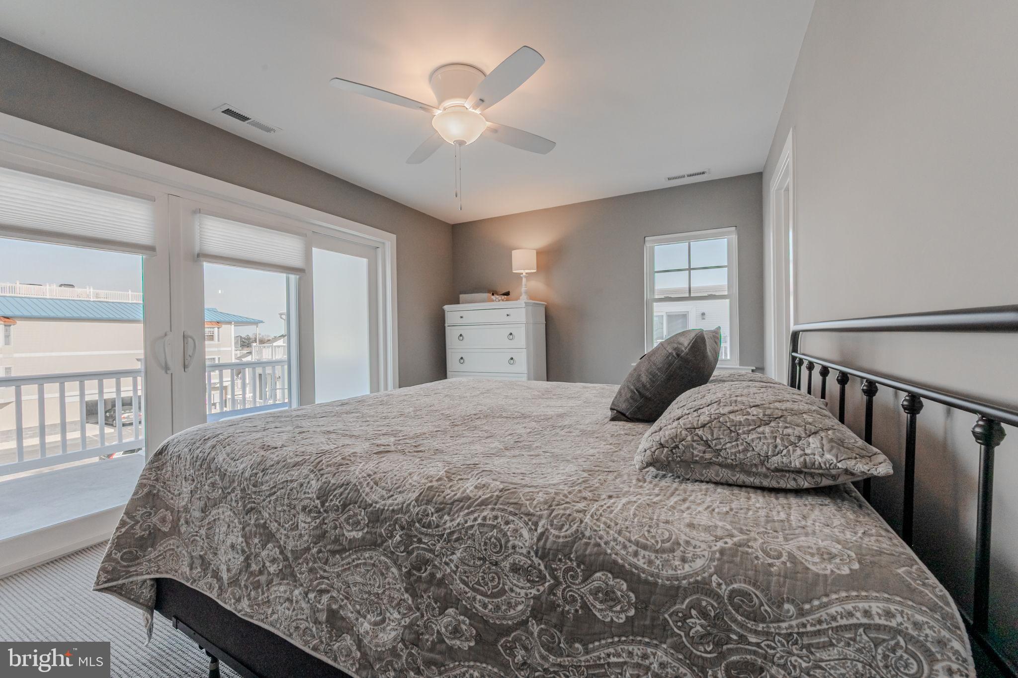 100 Anglers Road, Unit A4 Lewes, DE 19958 - Photo 34 of 57 a bedroom with a large bed and a chandelier