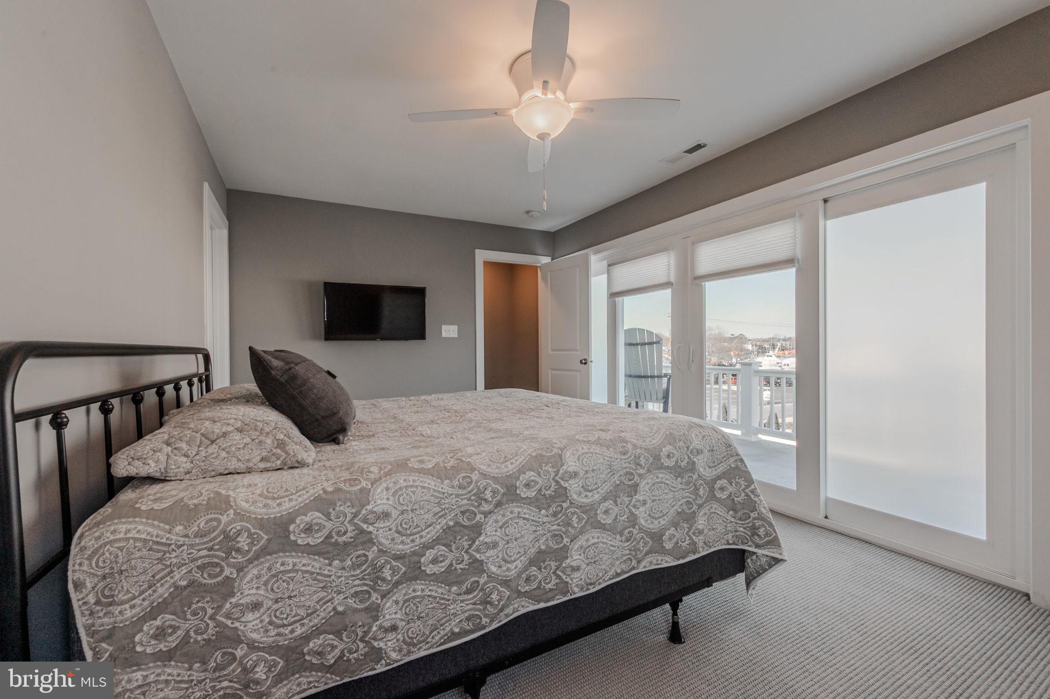 100 Anglers Road, Unit A4 Lewes, DE 19958 - Photo 36 of 57 a bedroom with a large bed and a large window