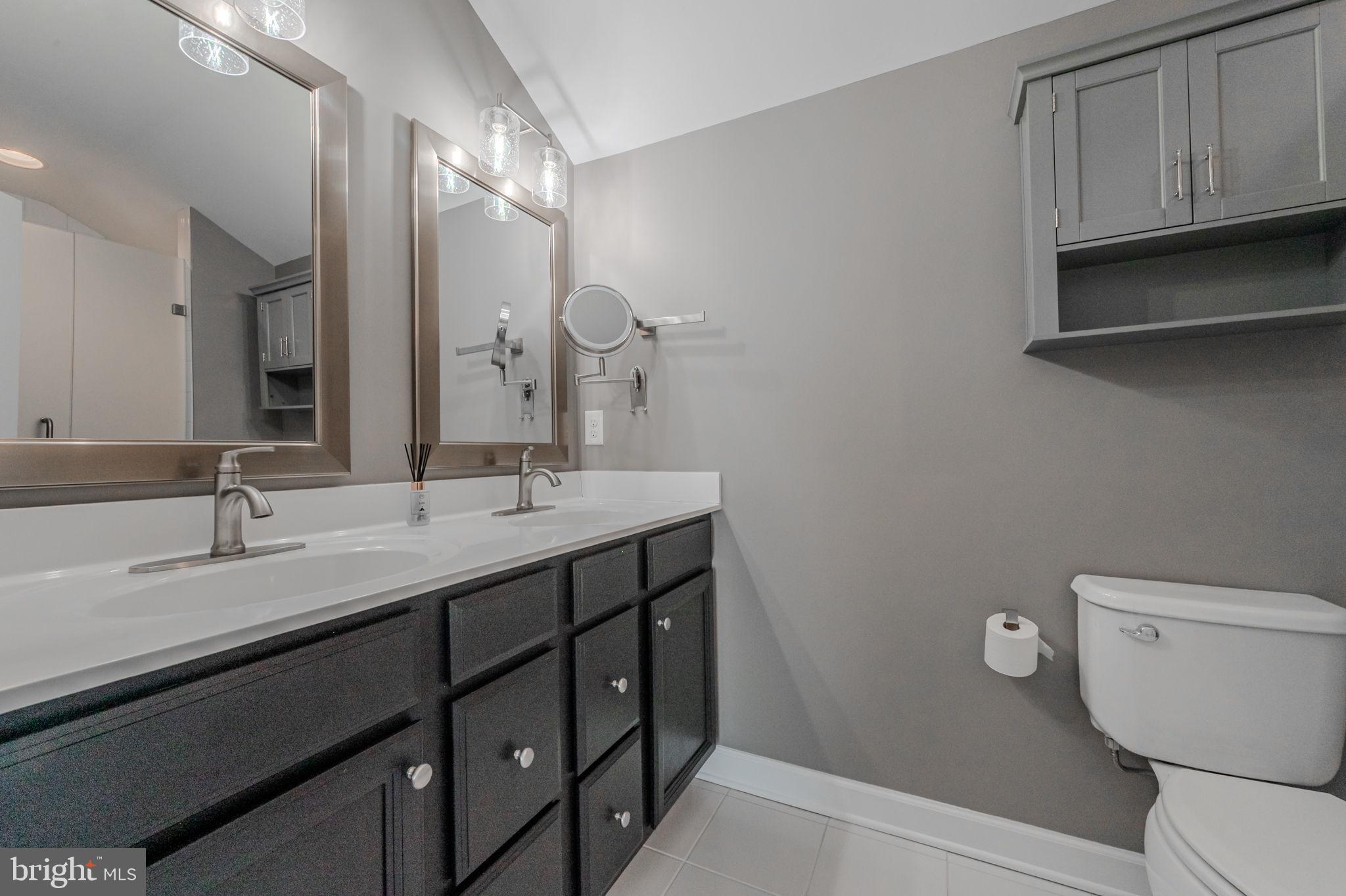 100 Anglers Road, Unit A4 Lewes, DE 19958 - Photo 38 of 57 a bathroom with a granite countertop sink a toilet and a mirror