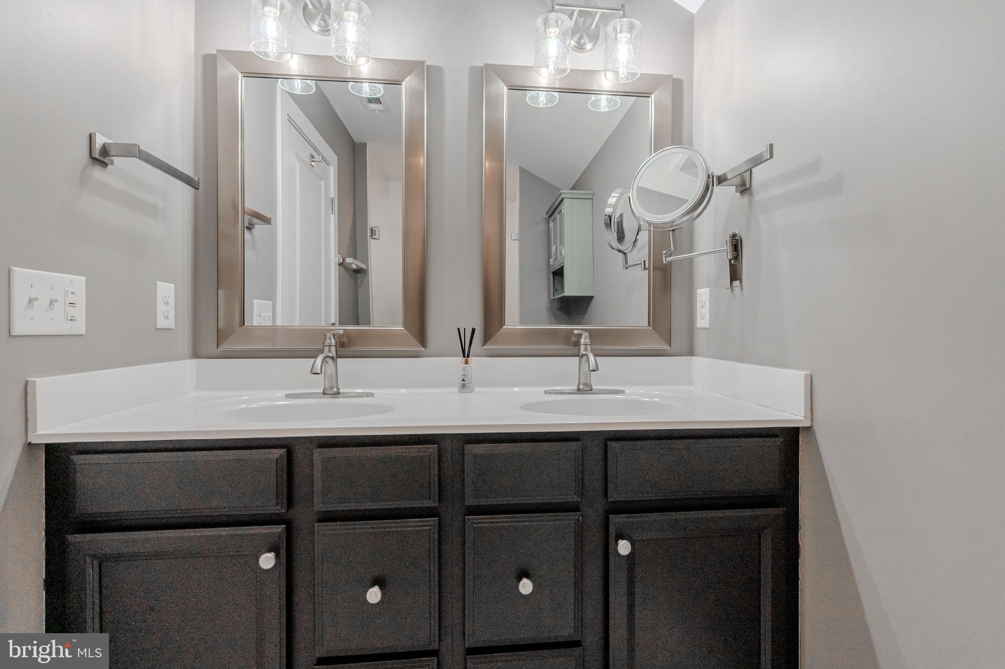 100 Anglers Road, Unit A4 Lewes, DE 19958 - Photo 41 of 57 a bathroom with a double vanity sink and a mirror