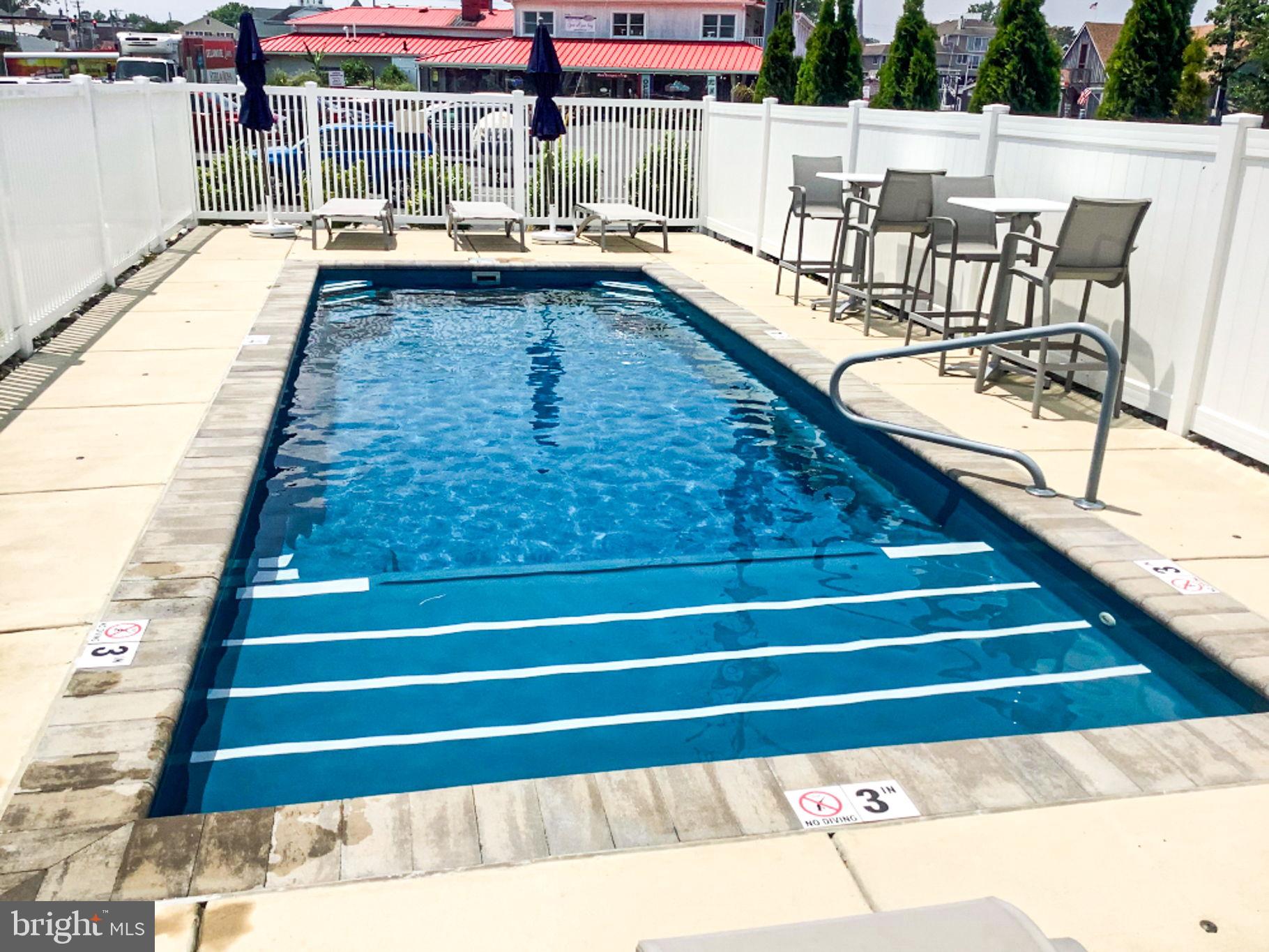 100 Anglers Road, Unit A4 Lewes, DE 19958 - Photo 50 of 57 a swimming pool view with a outdoor seating