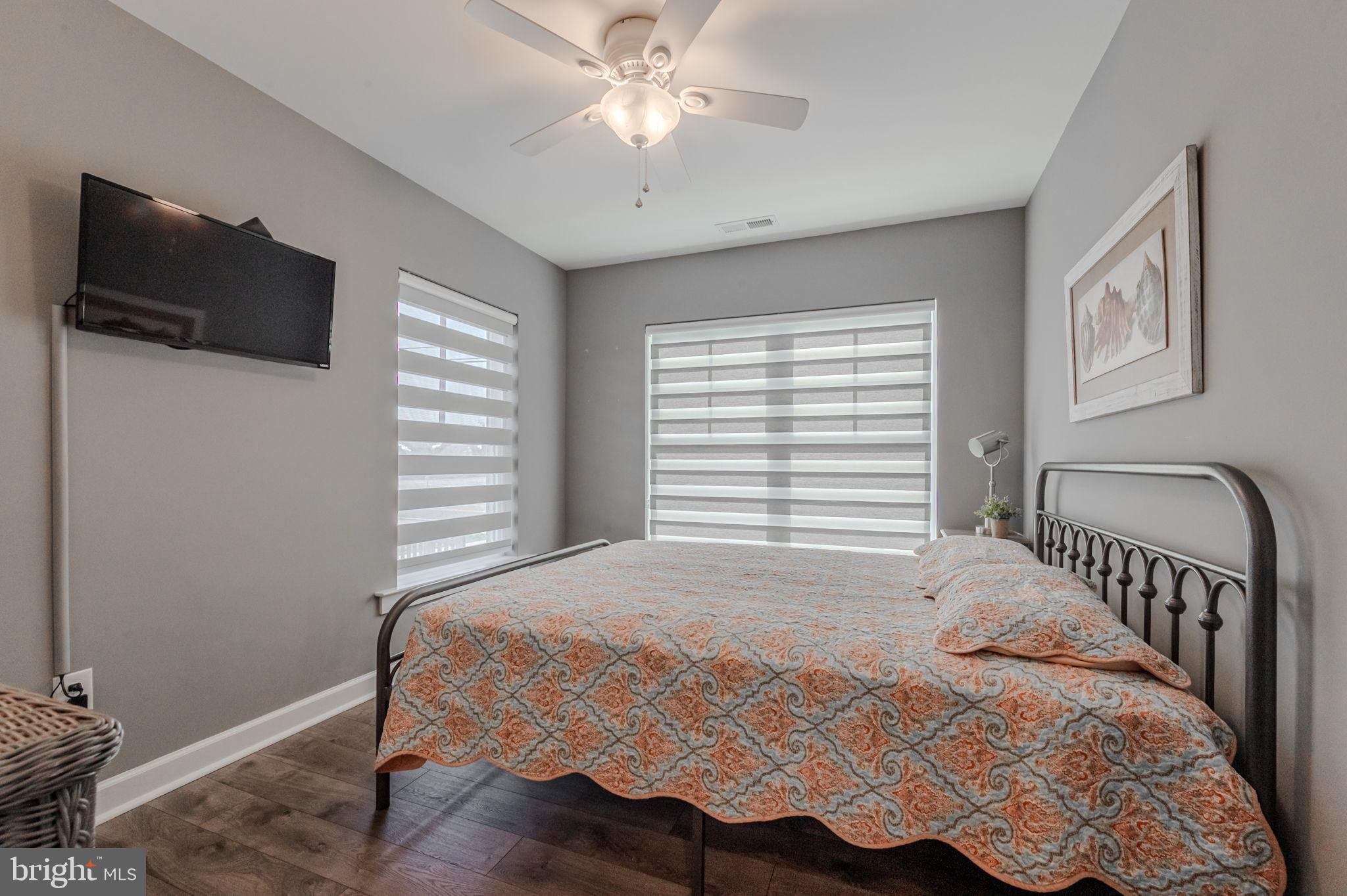 100 Anglers Road, Unit A4 Lewes, DE 19958 - Photo 8 of 57 a bedroom with a bed and a flat screen tv