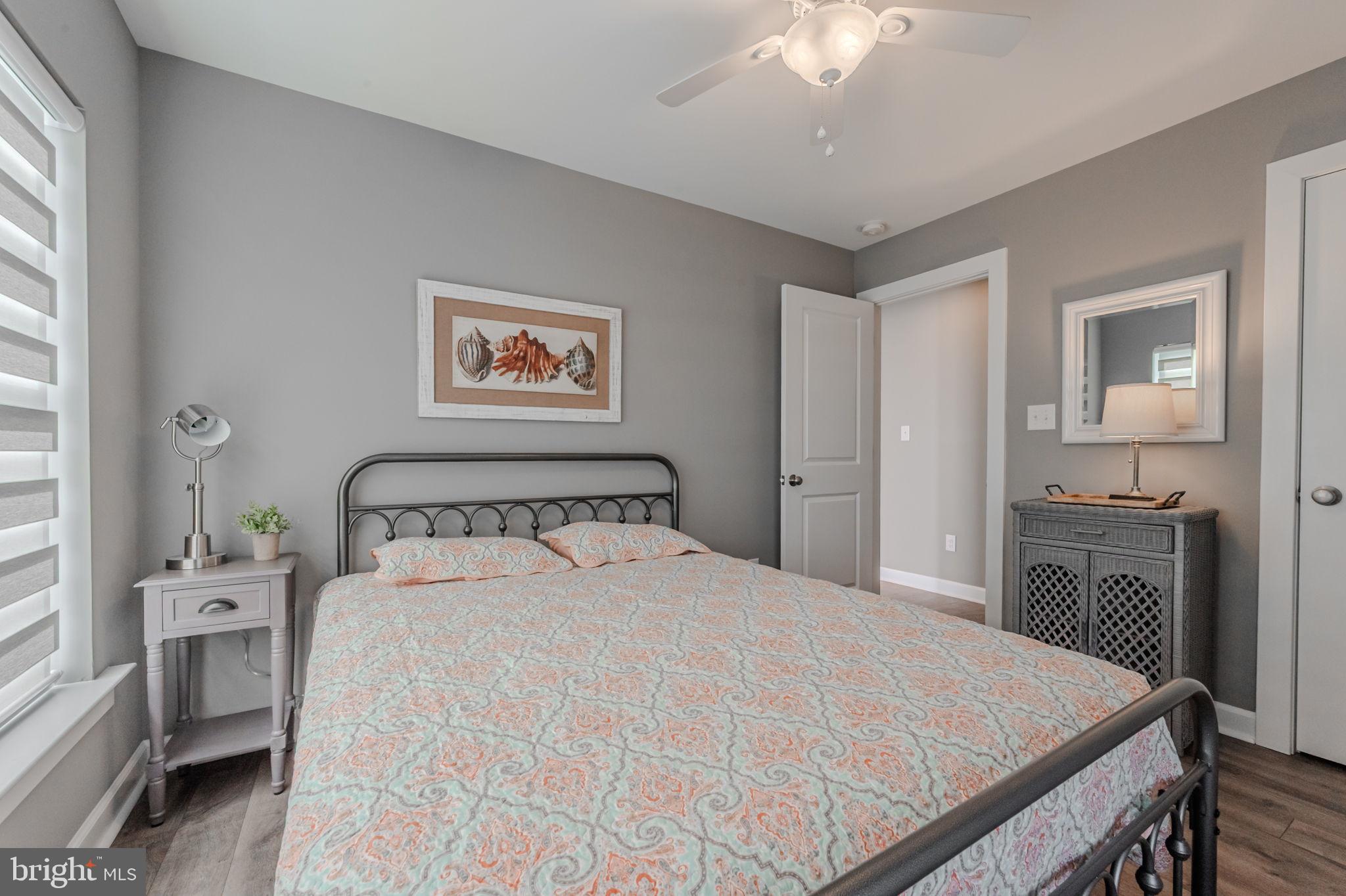 100 Anglers Road, Unit A4 Lewes, DE 19958 - Photo 9 of 57 a bedroom with a large bed and a chandelier