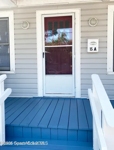 a view of wooden floor in a white room