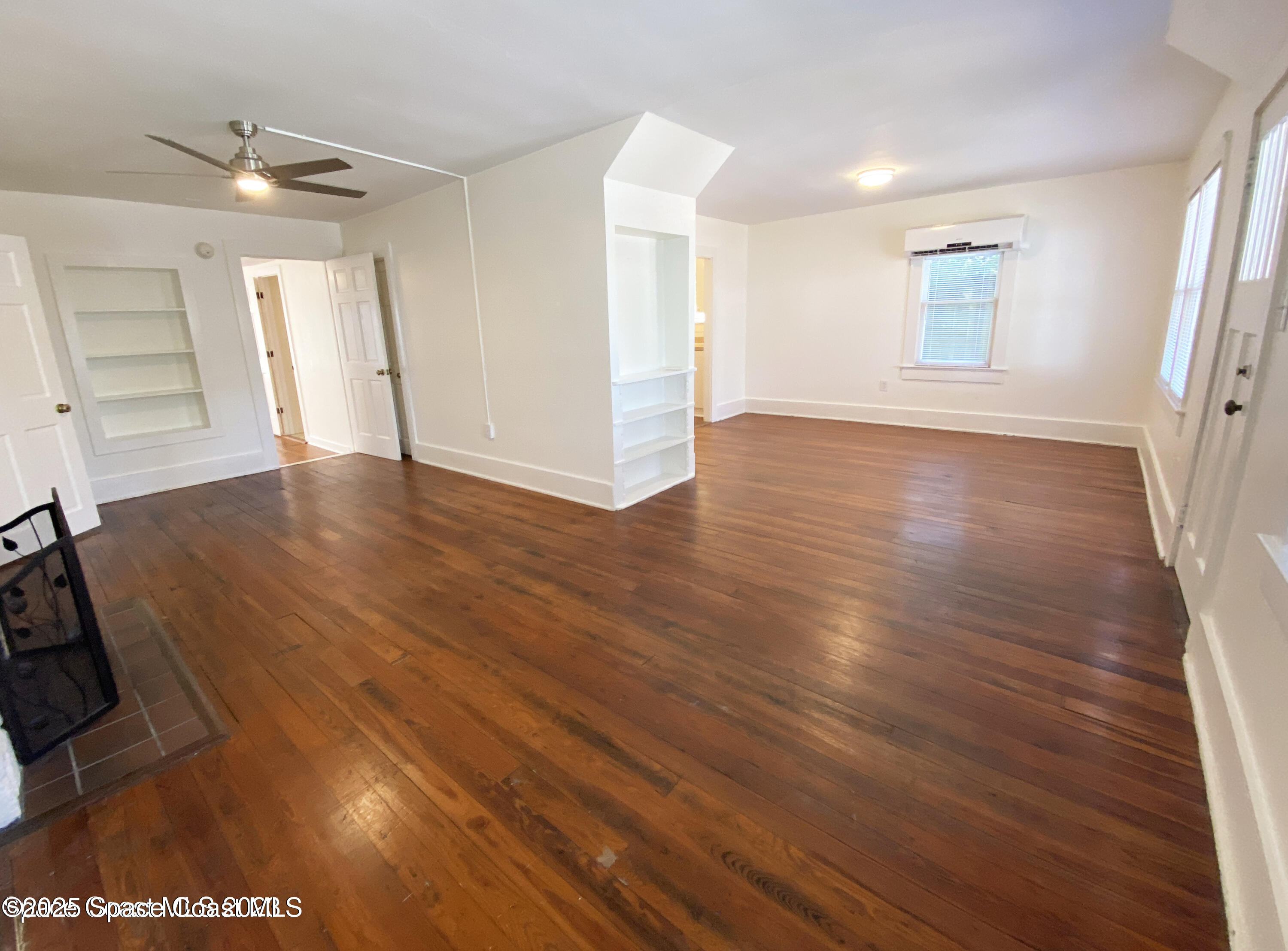 15 Parkway Street, Unit A Cocoa, FL 32922 - Photo 21 of 25 an empty room with wooden floor and windows