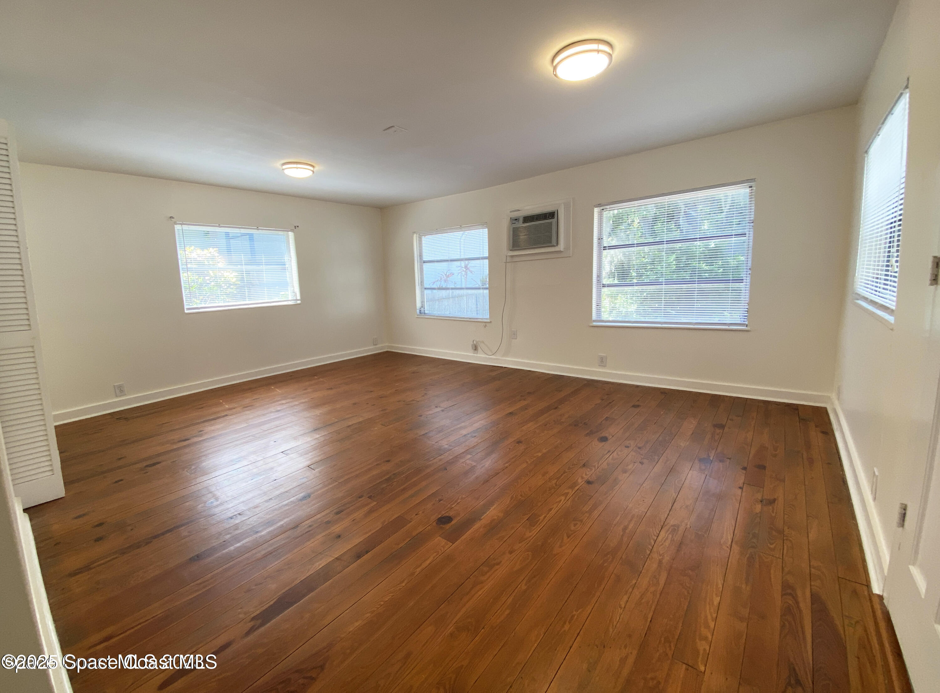 15 Parkway Street, Unit A Cocoa, FL 32922 - Photo 23 of 25 a view of an empty room with wooden floor and a window