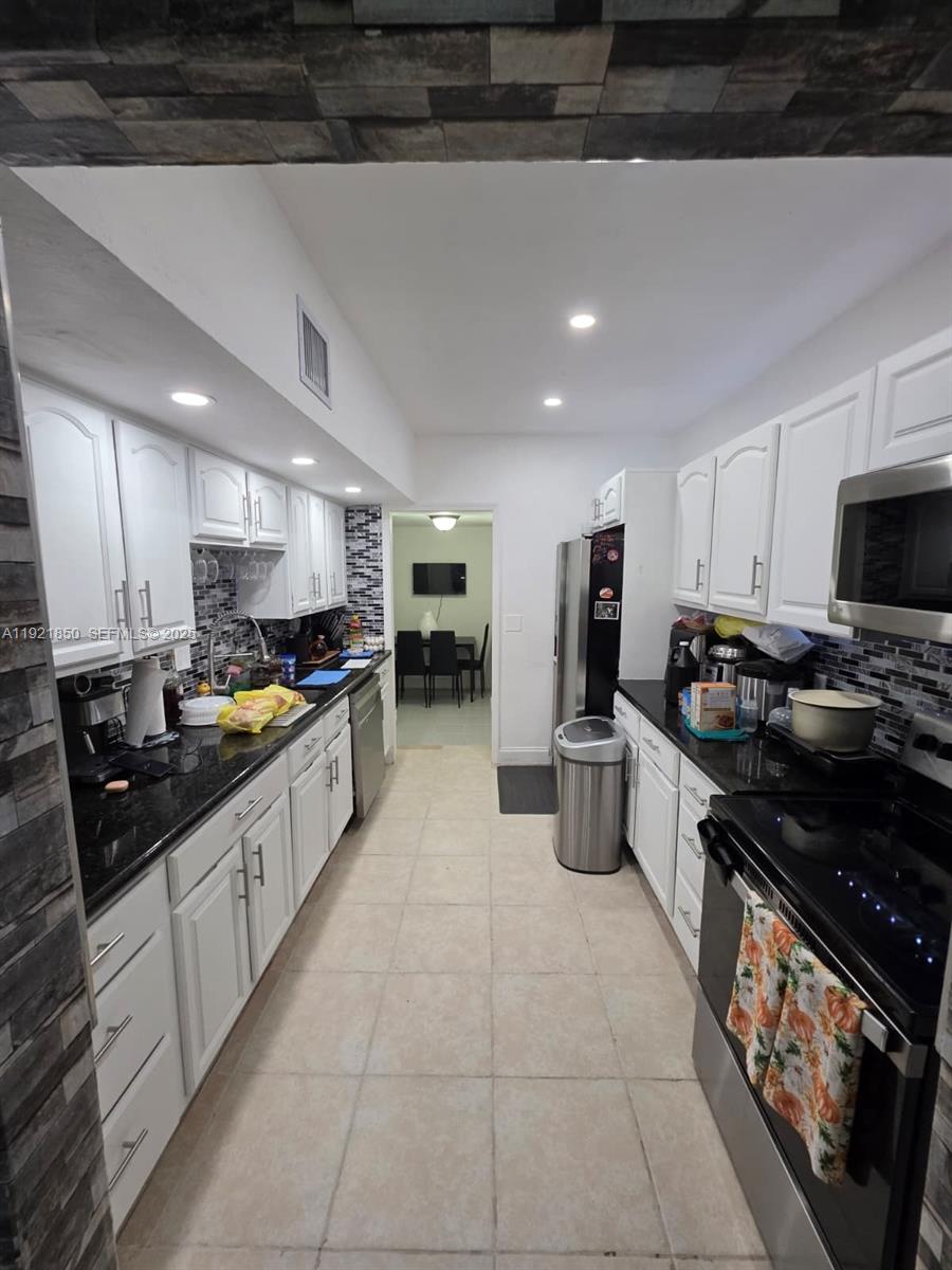 30232 Southwest 172nd Avenue Homestead, FL 33030 - Photo 11 of 31 a open kitchen with stainless steel appliances granite countertop a sink and cabinets