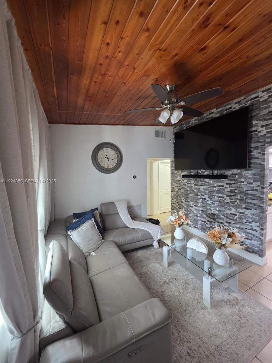 30232 Southwest 172nd Avenue Homestead, FL 33030 - Photo 12 of 31 a living room with furniture and a flat screen tv