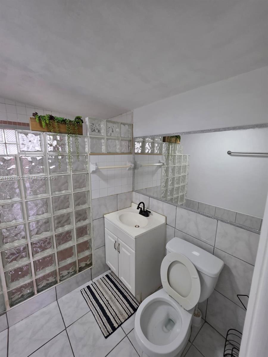 30232 Southwest 172nd Avenue Homestead, FL 33030 - Photo 16 of 31 a white toilet sitting next to a bathroom sink
