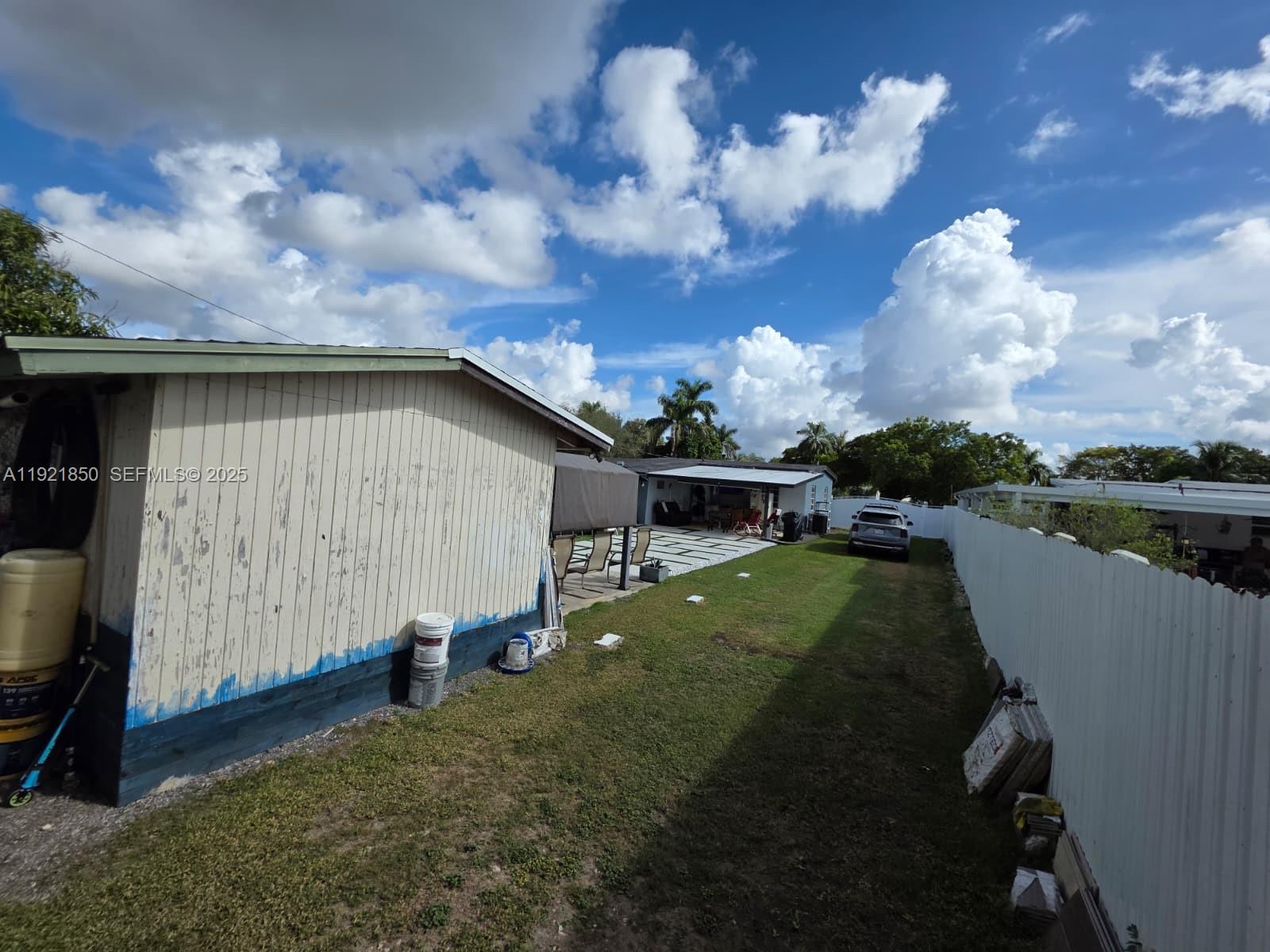 30232 Southwest 172nd Avenue Homestead, FL 33030 - Photo 27 of 31 a backyard of a house with lots of green space