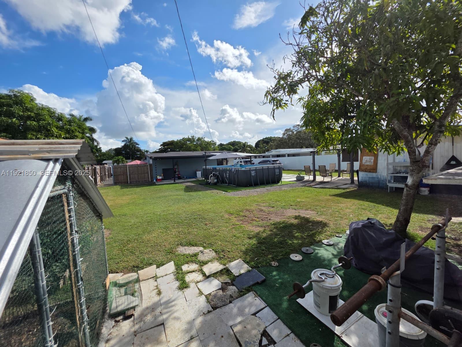 30232 Southwest 172nd Avenue Homestead, FL 33030 - Photo 28 of 31 a view of a swimming pool with a patio