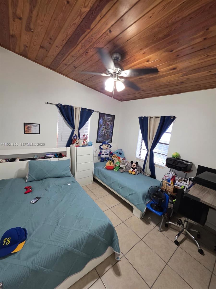 30232 Southwest 172nd Avenue Homestead, FL 33030 - Photo 10 of 31 a bed room with a bed and a chair