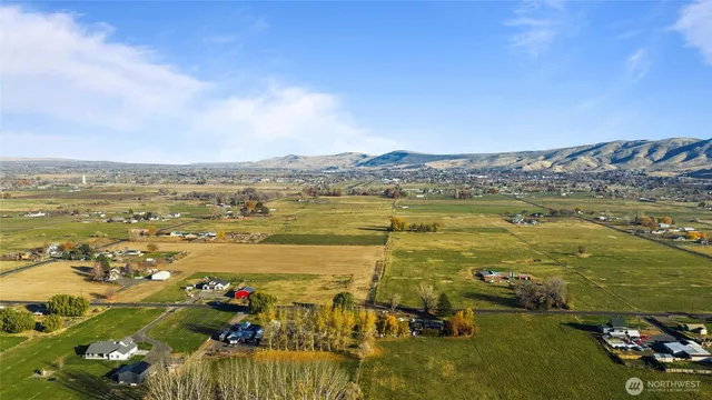 an aerial view of a house with a yard and lake view