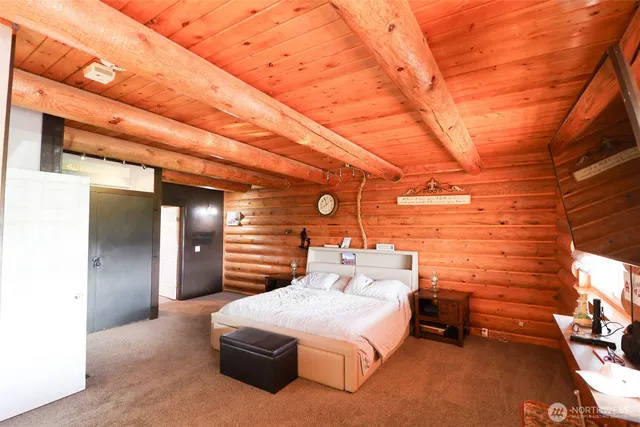 a bedroom with a bed and a night stand