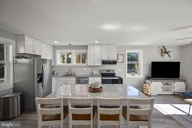 a kitchen with refrigerator and microwave