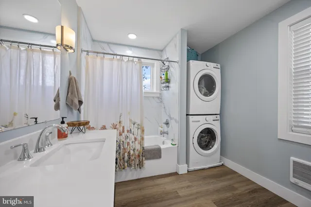 a bathroom with a sink a washer and dryer