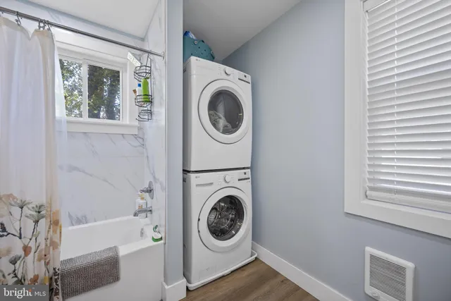 a utility room with sink dryer and washer