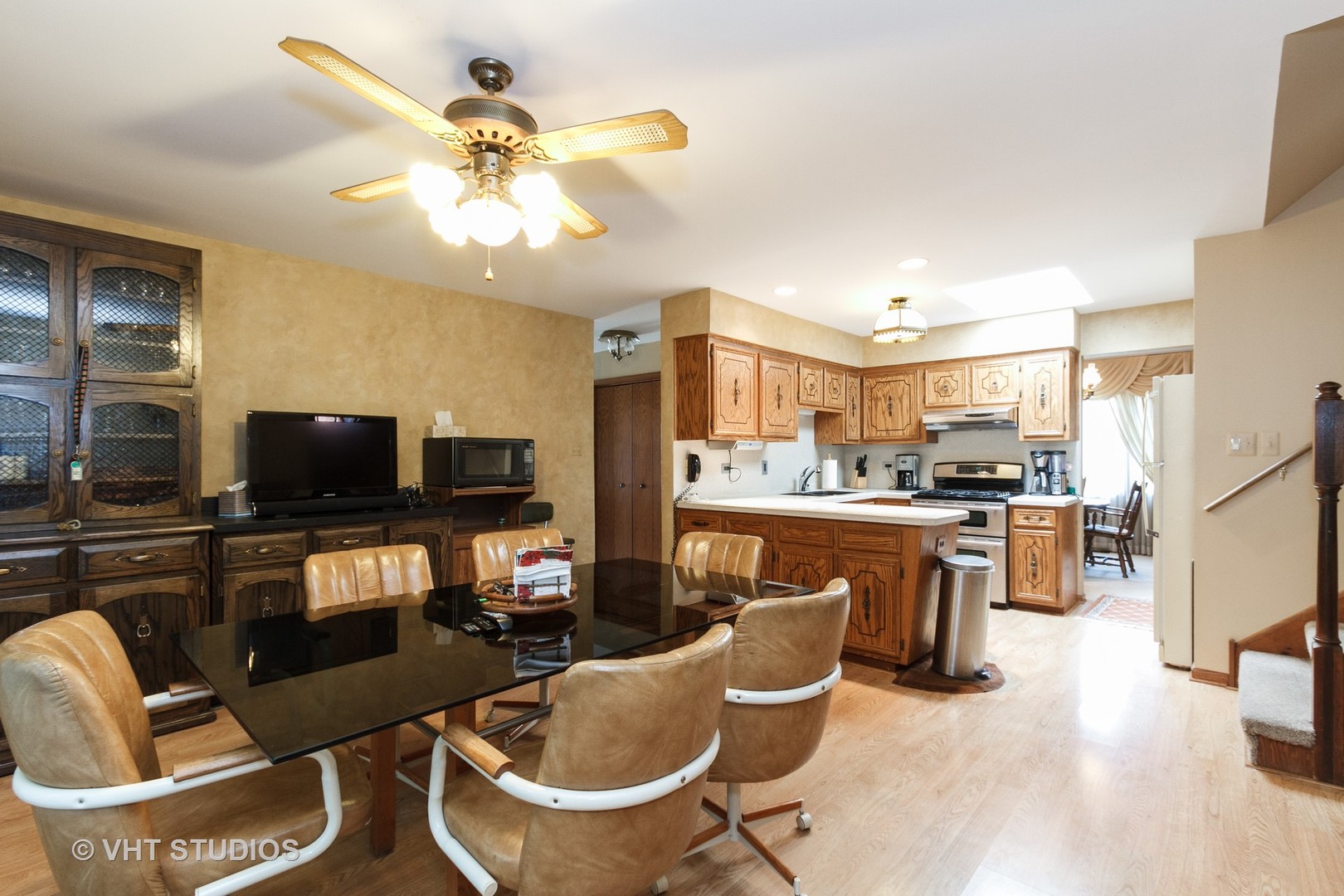 6931 Coachwood Trail Tinley Park, IL 60477 - Photo 4 of 11 a living room with couches a flat screen tv and kitchen view