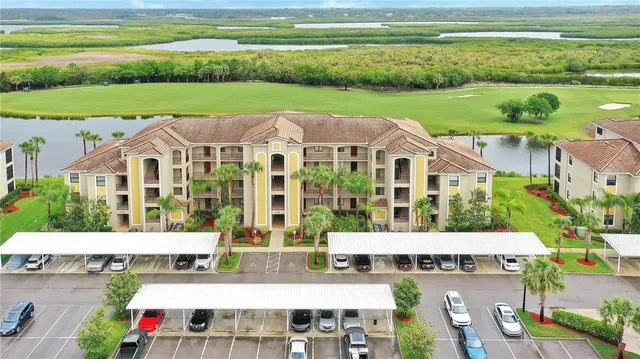 a aerial view of residential houses with outdoor space and ocean view