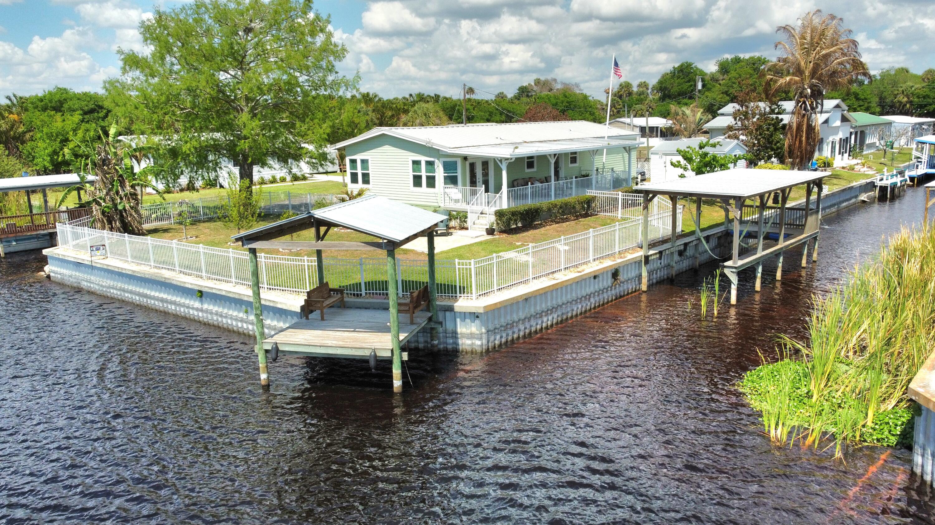 7902 Southeast 95th Trail Okeechobee, FL 34974 - Photo 1 of 36 a view of a lake with a patio