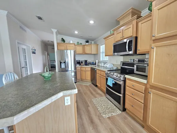 a spacious bedroom with a bed and a chandelier