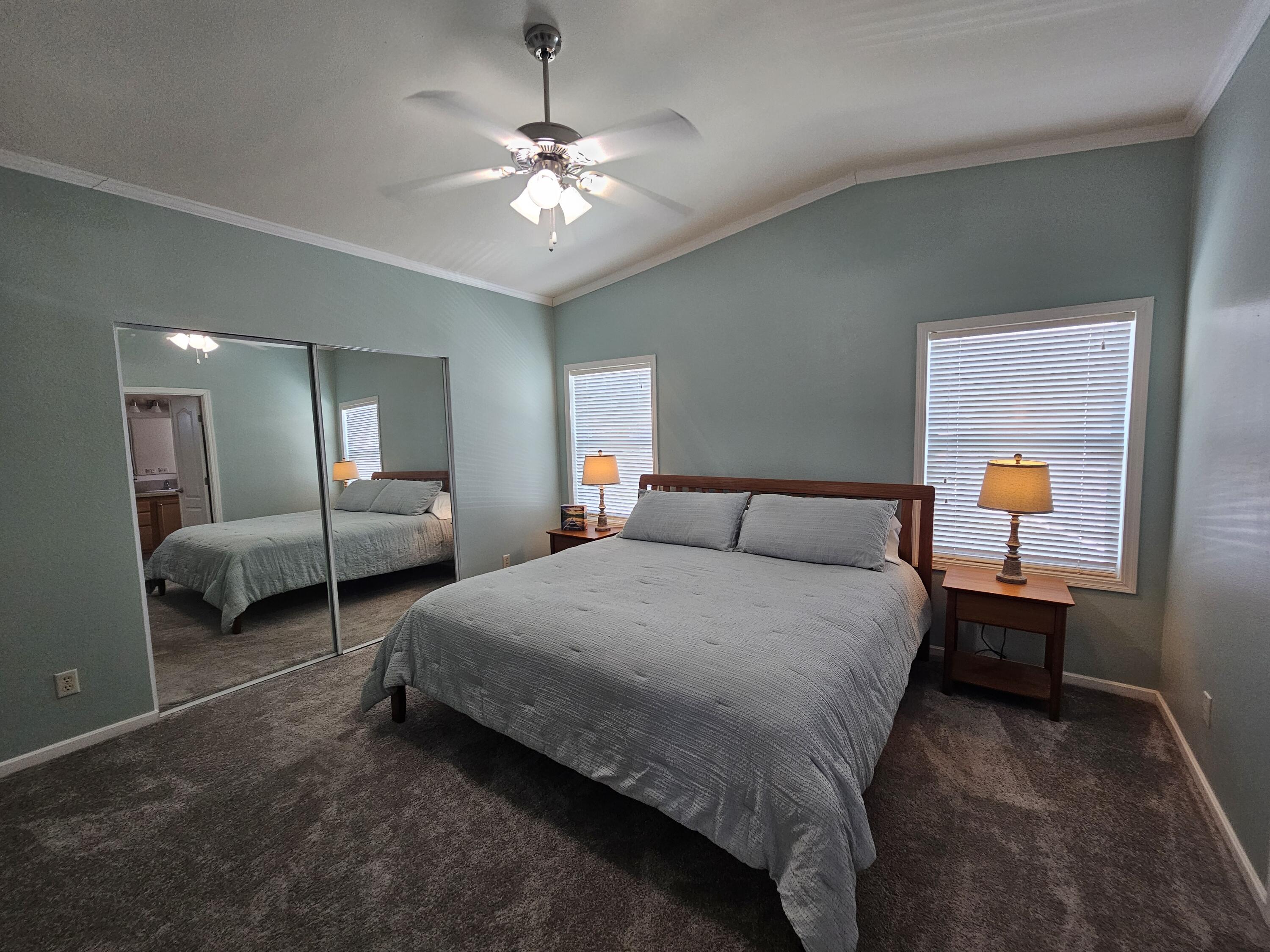 7902 Southeast 95th Trail Okeechobee, FL 34974 - Photo 21 of 36 a spacious bedroom with a bed and window