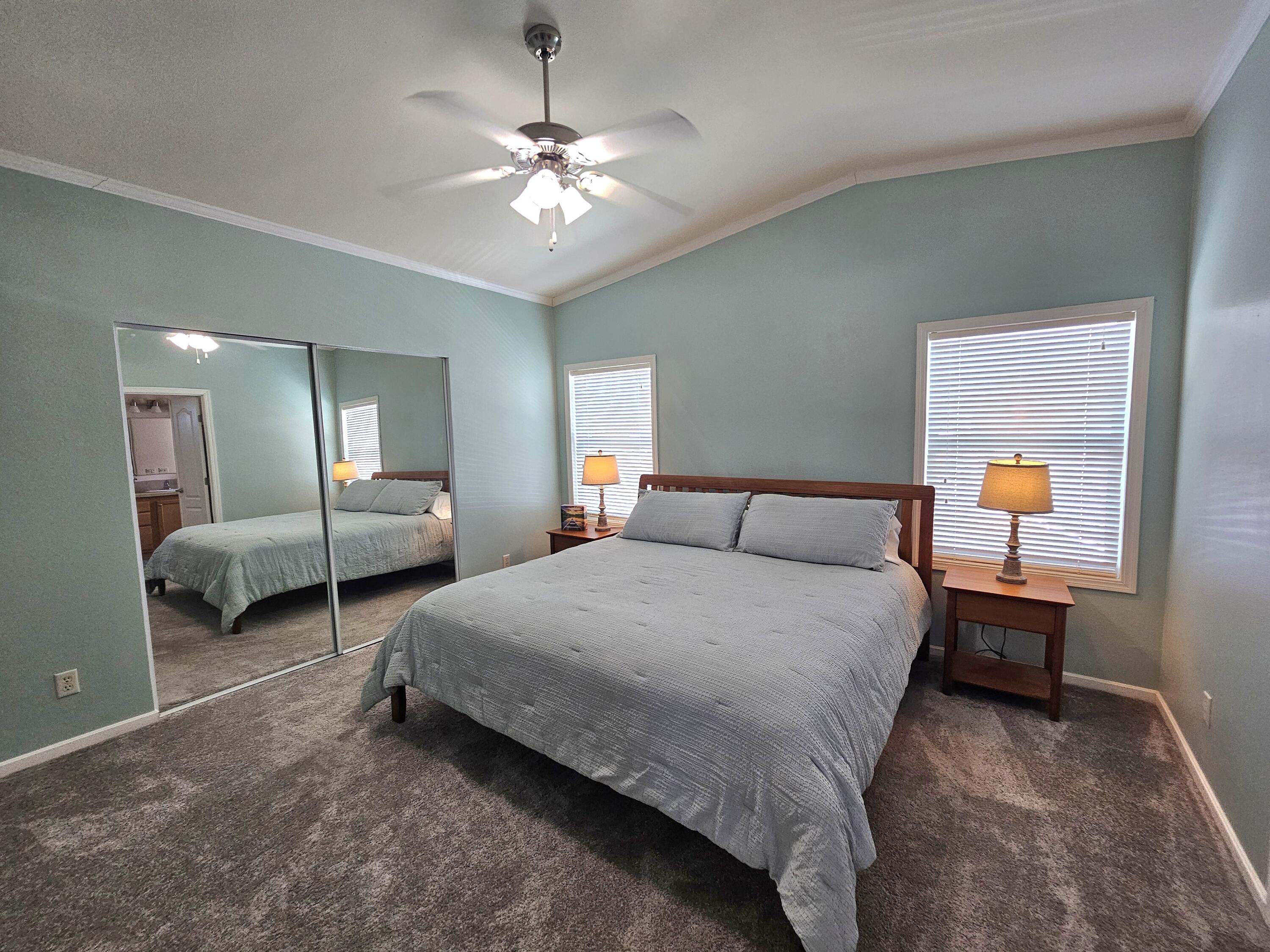 7902 Southeast 95th Trail Okeechobee, FL 34974 - Photo 22 of 36 a spacious bedroom with a bed and a chandelier