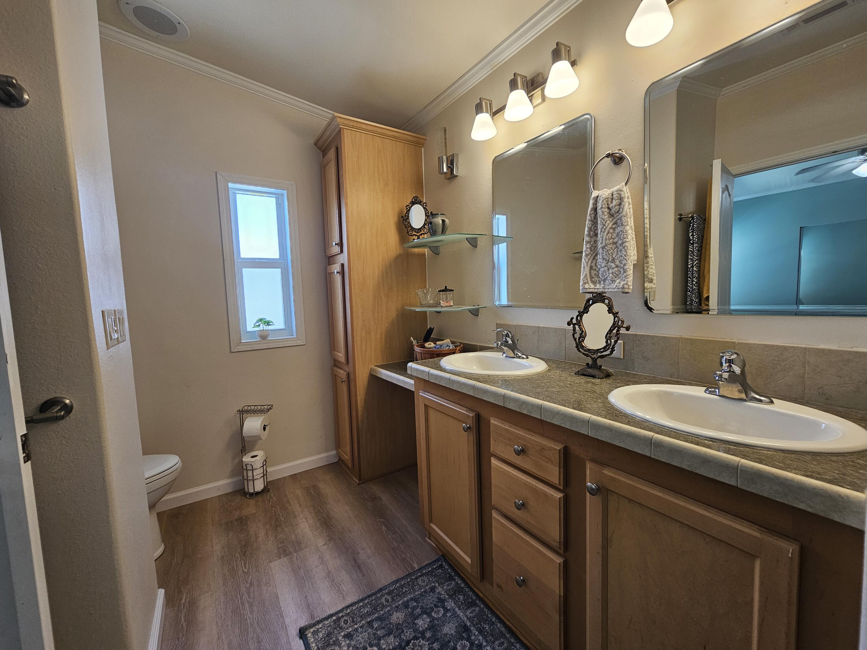 7902 Southeast 95th Trail Okeechobee, FL 34974 - Photo 23 of 36 a bathroom with a double vanity sink and a mirror