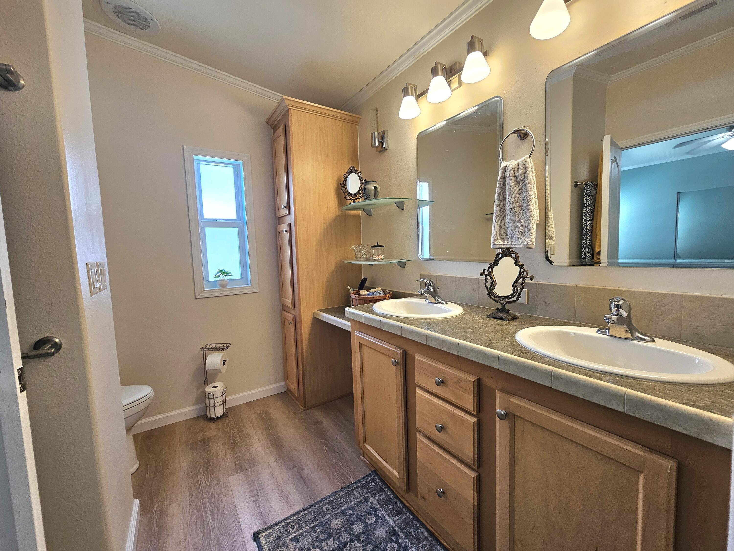 7902 Southeast 95th Trail Okeechobee, FL 34974 - Photo 24 of 36 a bathroom with a double vanity sink and a mirror