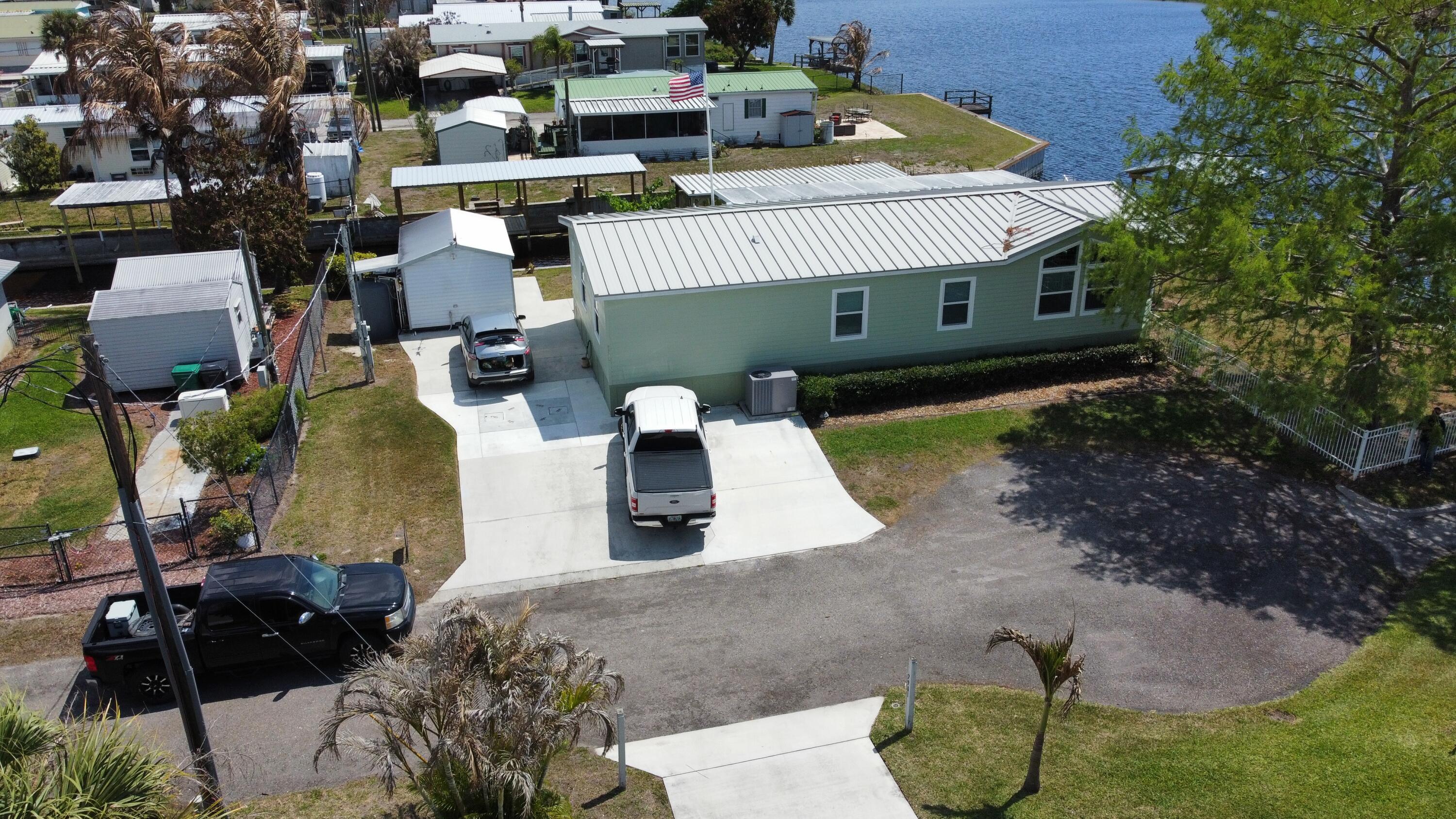 7902 Southeast 95th Trail Okeechobee, FL 34974 - Photo 27 of 36 an aerial view of a house with a yard and a garage