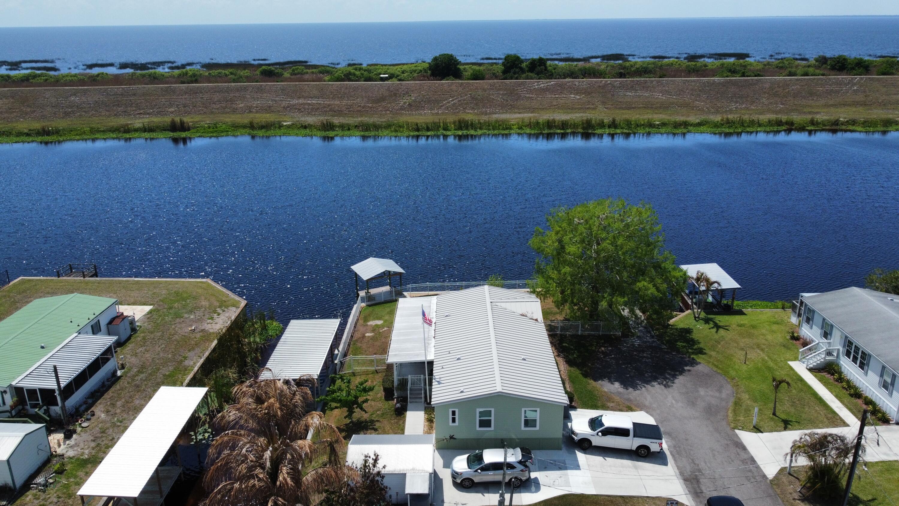 7902 Southeast 95th Trail Okeechobee, FL 34974 - Photo 29 of 36 an aerial view of a house with a lake view