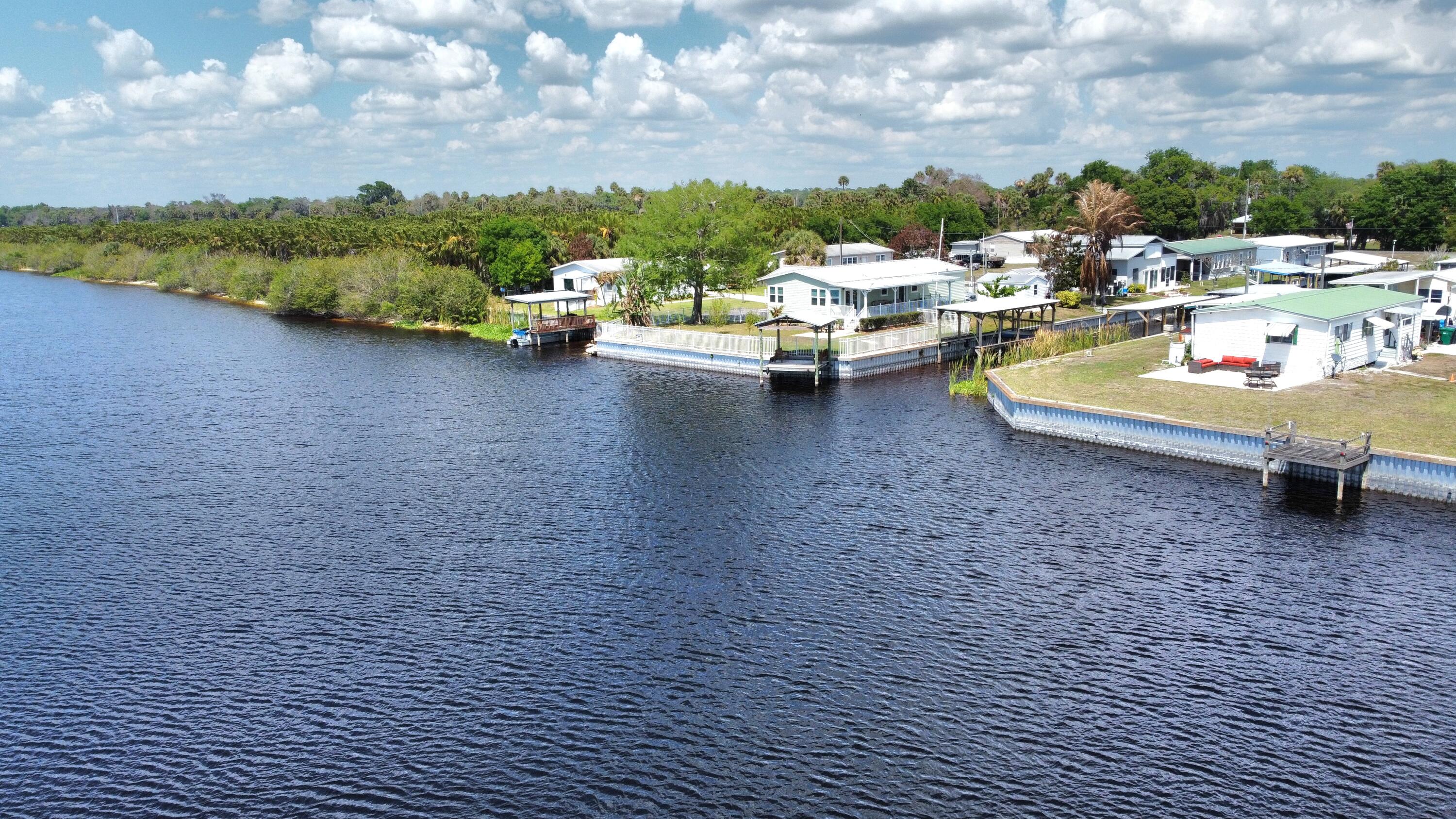 7902 Southeast 95th Trail Okeechobee, FL 34974 - Photo 32 of 36 a view of a lake with roof top