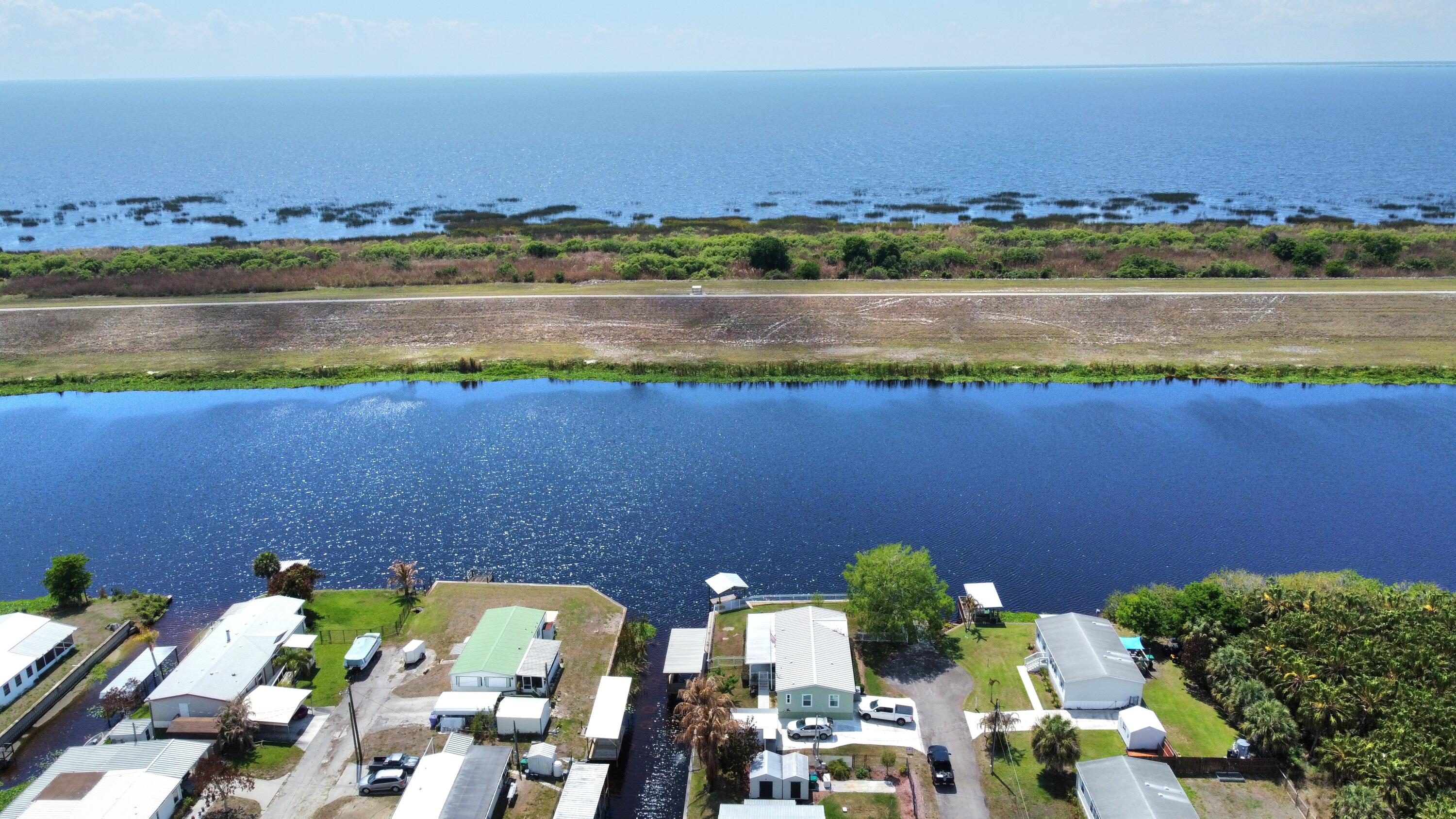 7902 Southeast 95th Trail Okeechobee, FL 34974 - Photo 35 of 36 an aerial view of ocean and residential houses with outdoor space