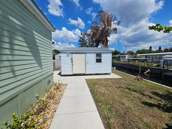a living room with furniture a chandelier and a window