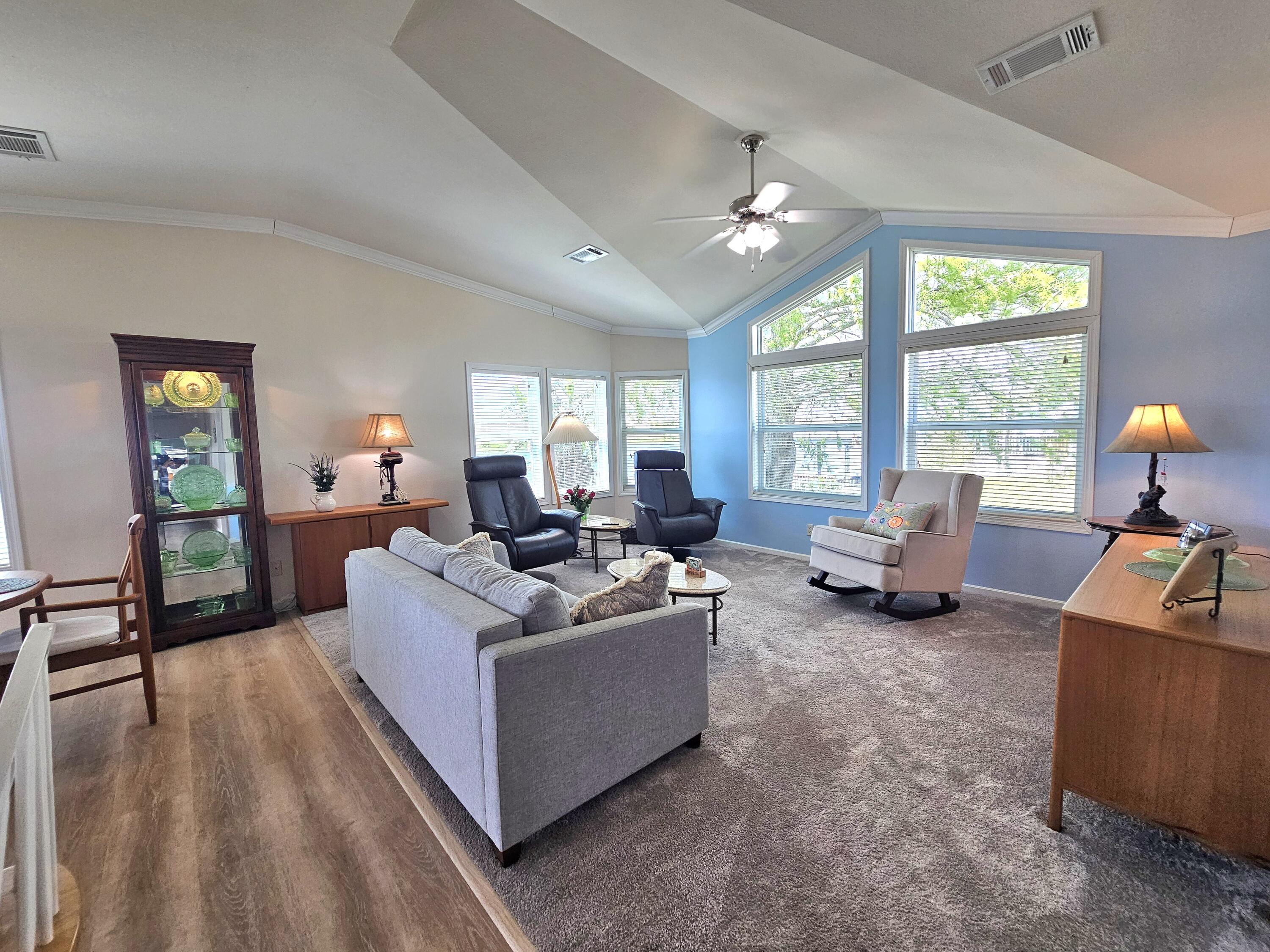 7902 Southeast 95th Trail Okeechobee, FL 34974 - Photo 8 of 36 a living room with furniture and a large window