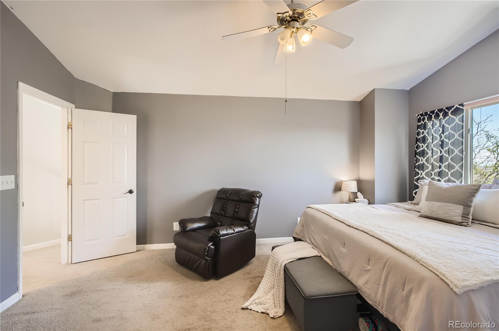 8481 West 95th Drive Westminster, CO 80021 - Photo 13 of 28 a bedroom with a bed and a chandelier