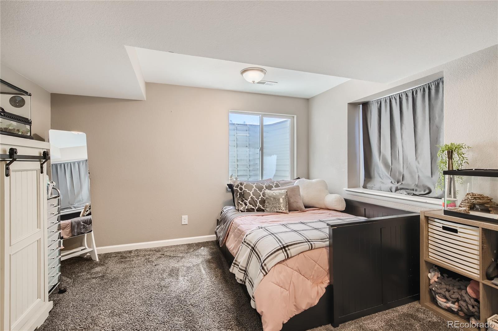 8481 West 95th Drive Westminster, CO 80021 - Photo 17 of 28 a bedroom with a bed and a window