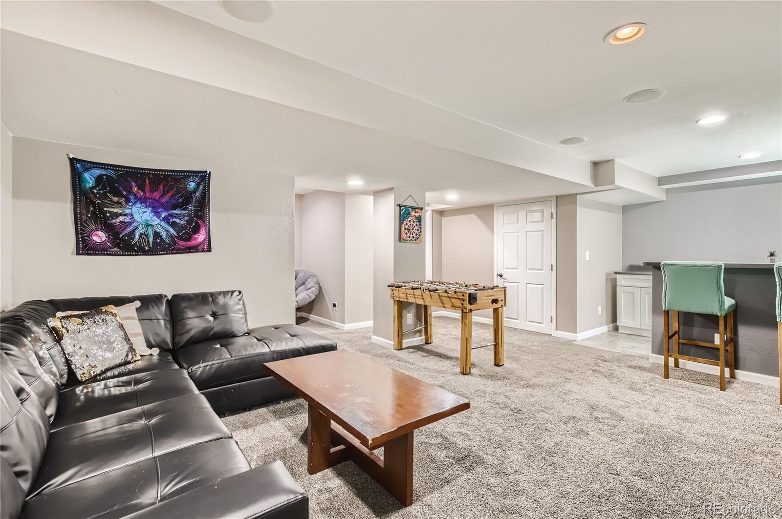 8481 West 95th Drive Westminster, CO 80021 - Photo 19 of 28 a living room with furniture and a table