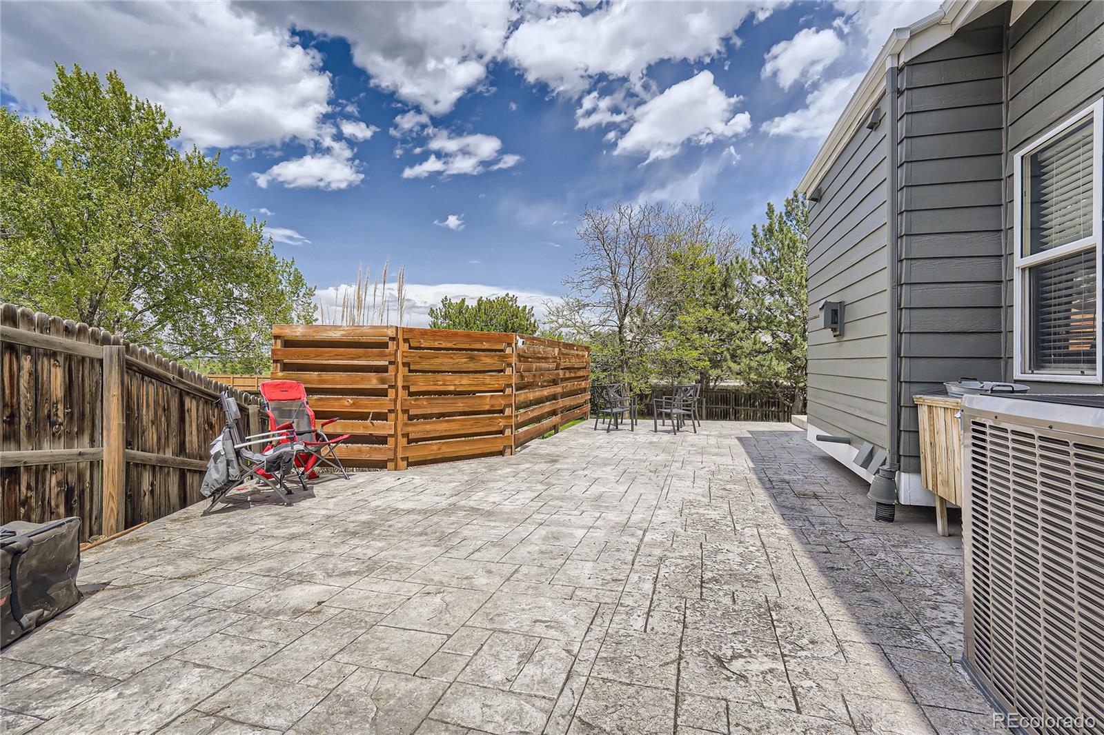 8481 West 95th Drive Westminster, CO 80021 - Photo 23 of 28 a view of backyard with wooden fence and trees