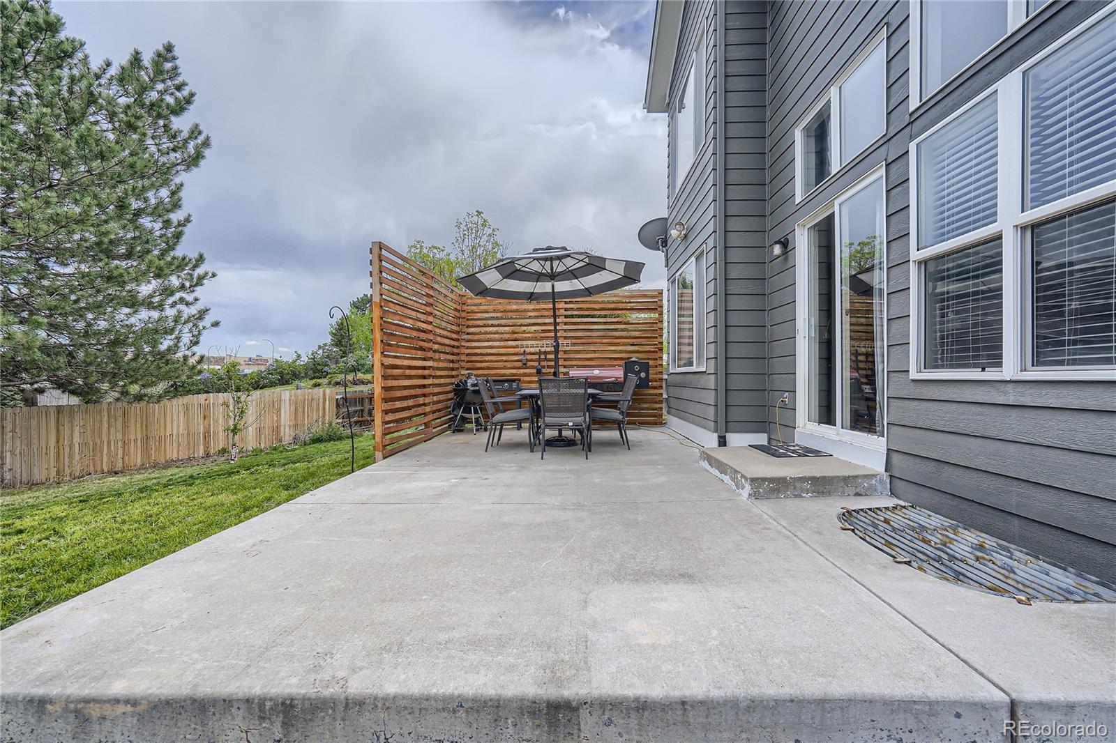 8481 West 95th Drive Westminster, CO 80021 - Photo 25 of 28 a view of a patio with table and chairs with wooden fence and plants