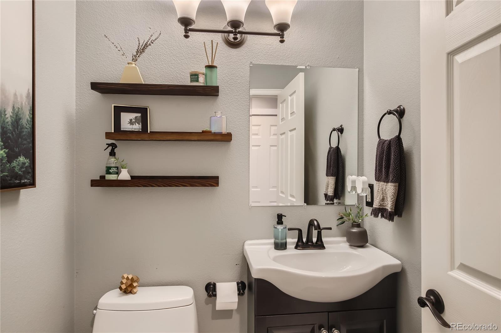8481 West 95th Drive Westminster, CO 80021 - Photo 27 of 28 a bathroom with a sink vanity and mirror