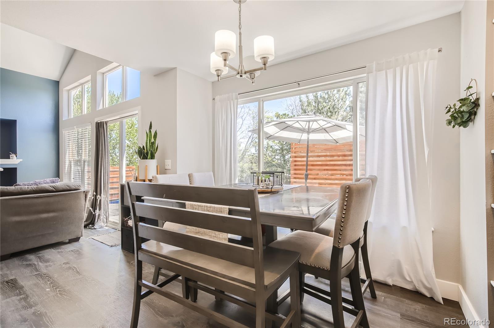 8481 West 95th Drive Westminster, CO 80021 - Photo 8 of 28 a view of a dining room with furniture window and wooden floor